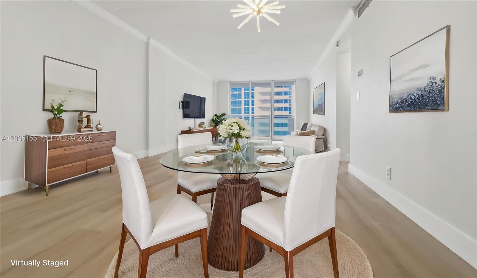A dining area features a glass-topped table, white chairs, and light wood flooring — 3001 S Ocean Dr # 1415, Hollywood FL 33019, HOLLYWOOD, FL