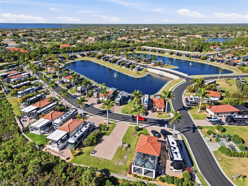 An aerial view of a luxury RV resort featuring paved roads, landscaped lots, and ponds — 14100 MYAKKA AVENUE UNIT 26, PORT CHARLOTTE, FL