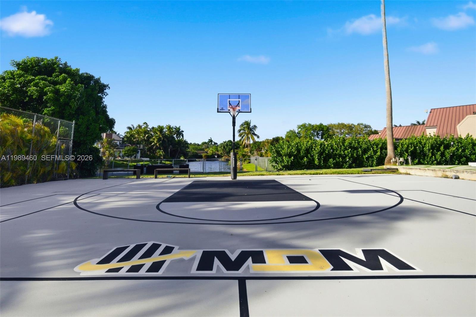 An outdoor basketball court features a hoop, a black key, and a painted logo — 2201 SW 115th Ter, Davie FL 33325, DAVIE, FL