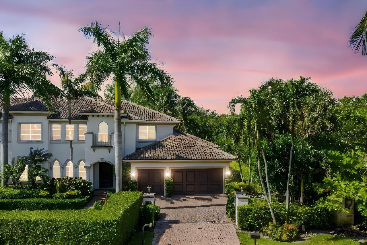 A two-story stucco house with a tile roof, palm trees, and a paved driveway — 4102 S Ocean Boulevard, Highland Beach FL 33487, HIGHLAND BEACH, FL