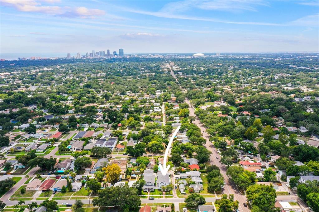 An aerial view of a residential neighborhood with a white arrow pointing to a house — 876 44TH AVENUE N, ST PETERSBURG, FL