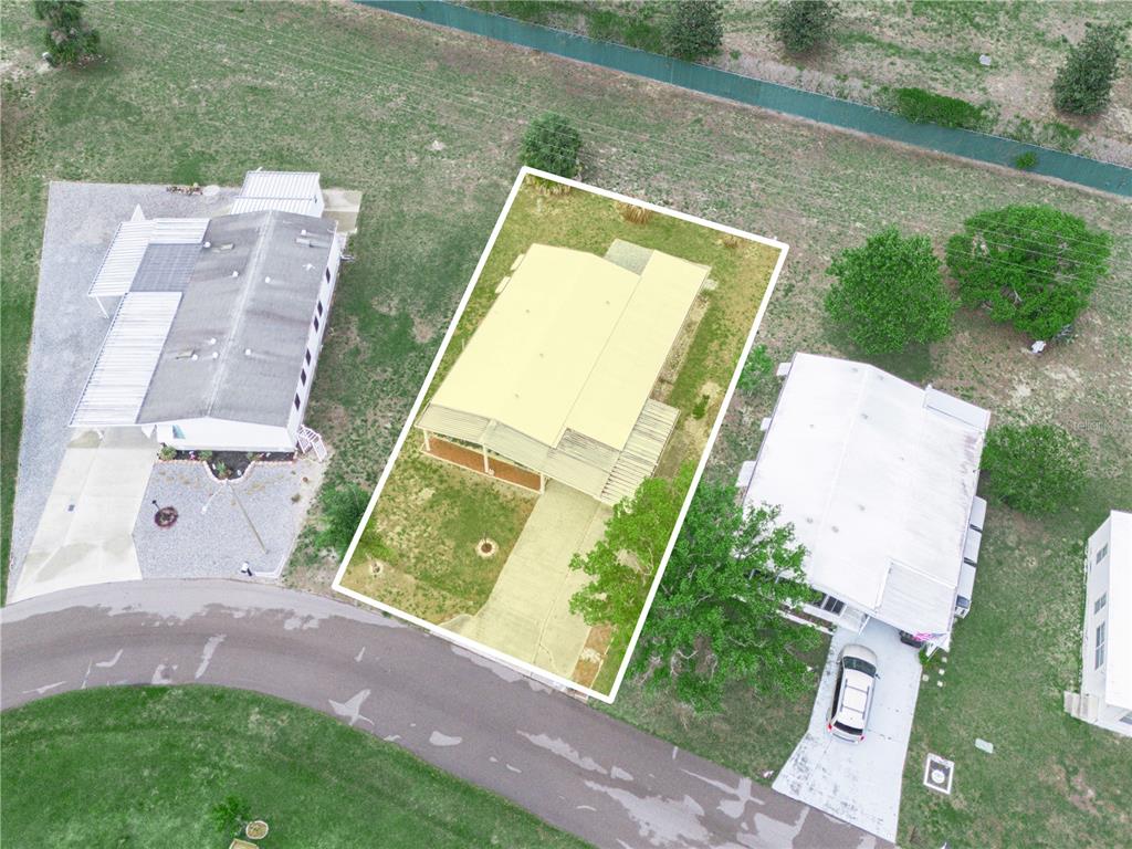 An aerial view shows a single-story house with a driveway and yard highlighted in yellow — 108 KENSINGTON PARK DRIVE, DAVENPORT, FL
