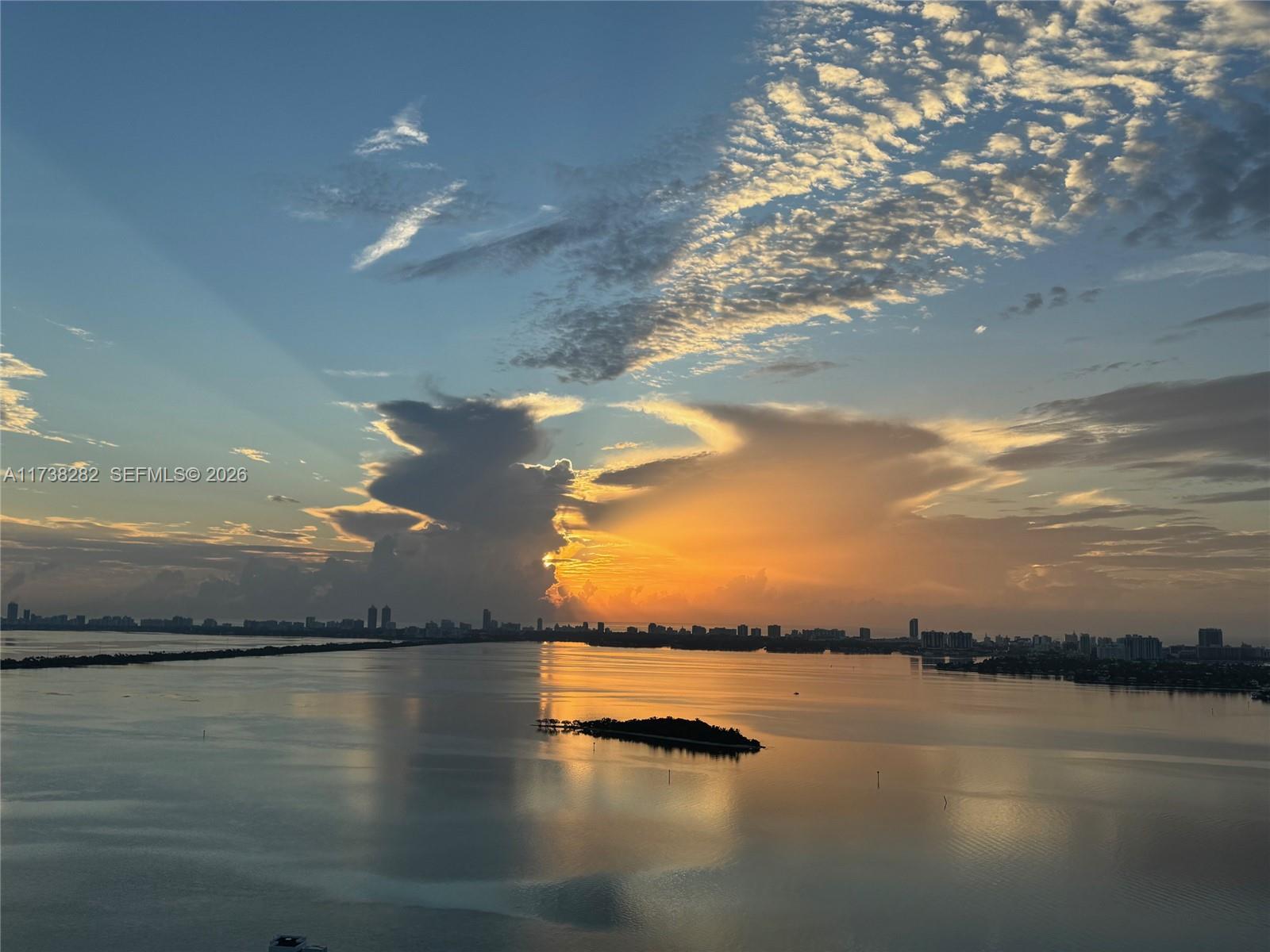 An aerial view of a calm bay with a small island at sunset — 2020 N Bayshore Dr # 3307, Miami FL 33137, MIAMI, FL