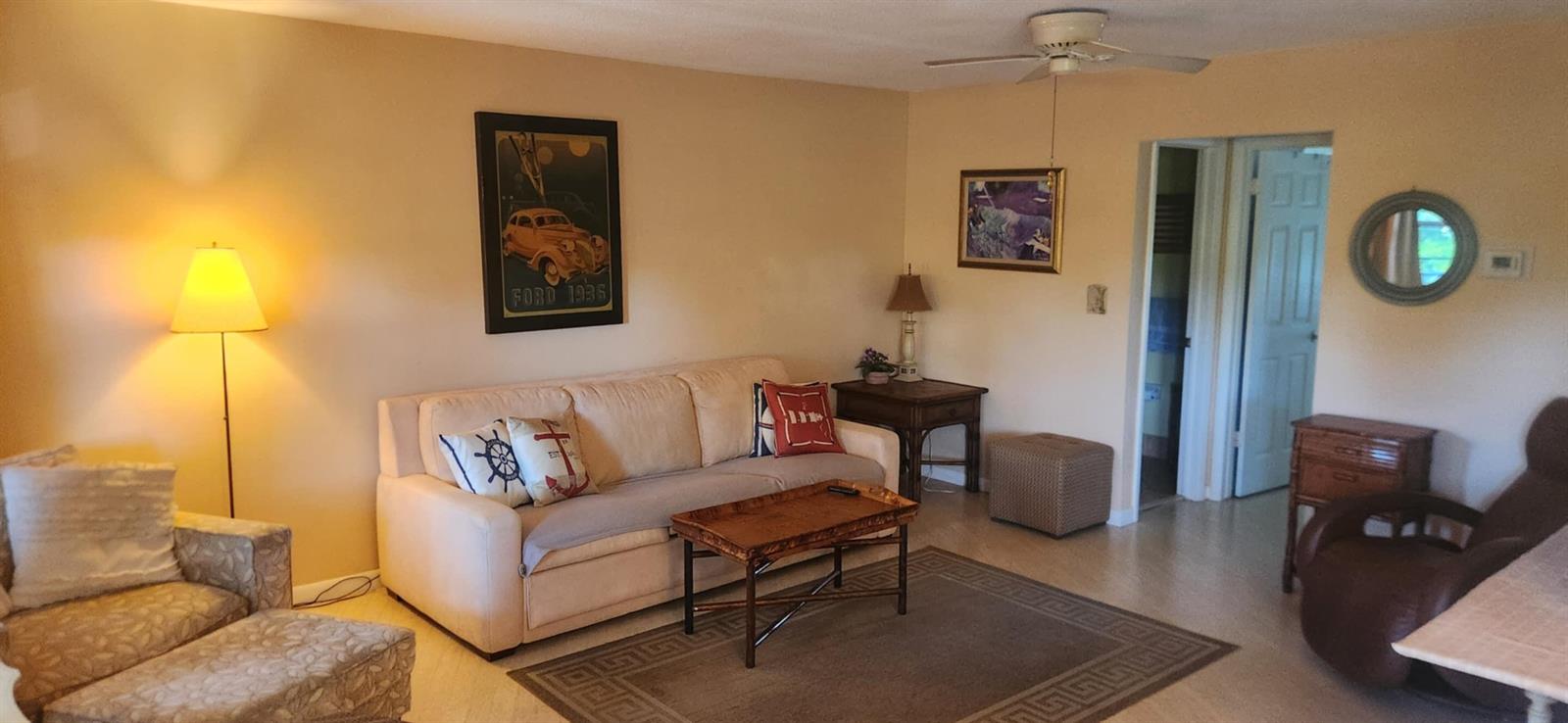 A living room features a beige sofa, a coffee table, and a patterned area rug — 5510 N Ocean # 206, Ocean Ridge FL 33435, OCEAN RIDGE, FL