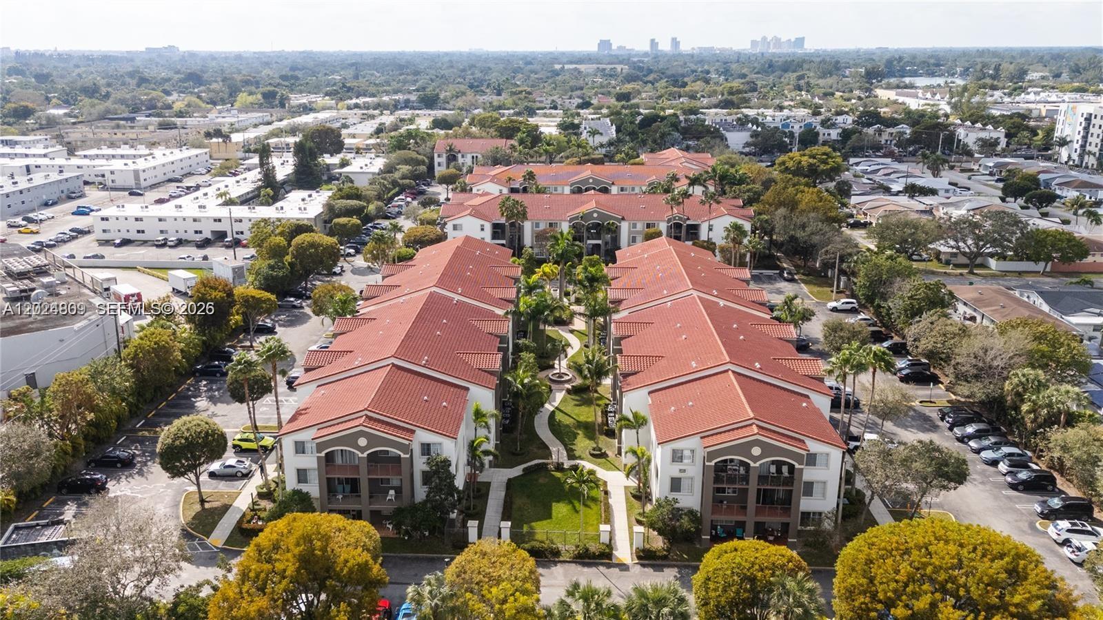 An aerial view shows two parallel apartment buildings with red tile roofs and central landscaping — 6851 SW 44th St # 207, Miami FL 33155, MIAMI, FL
