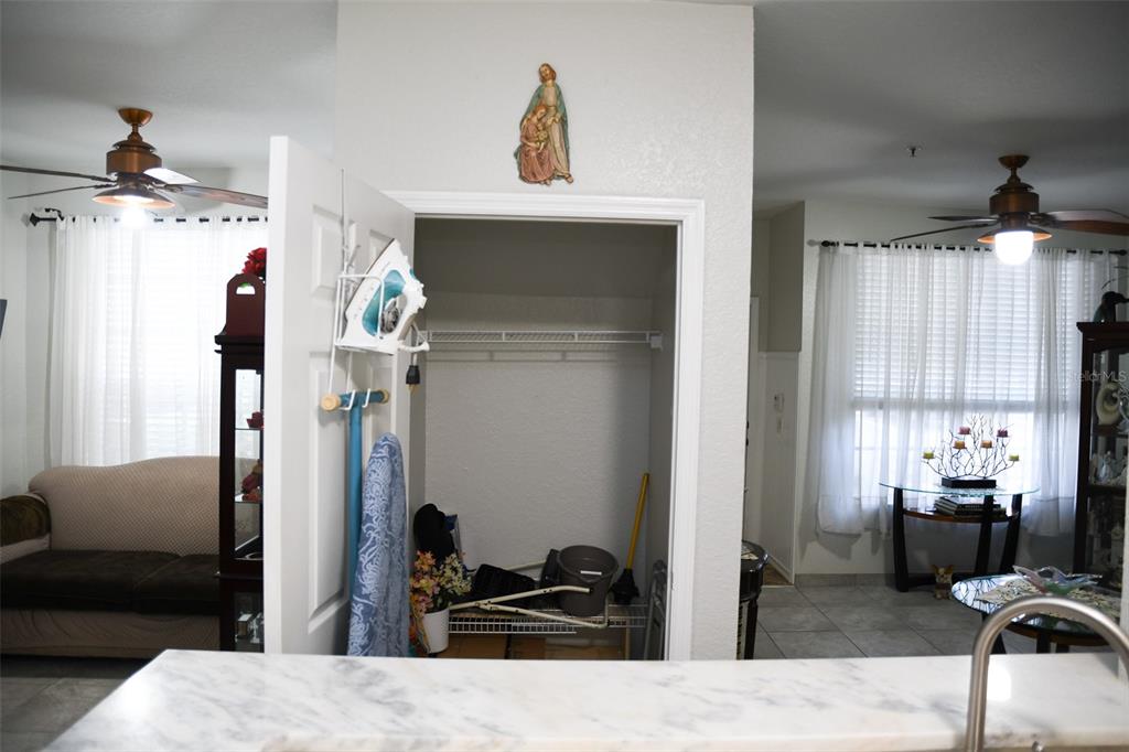 A view from a kitchen counter looking into a closet and adjacent living areas — 830 GRAND REGENCY POINT UNIT 101, ALTAMONTE SPRINGS, FL