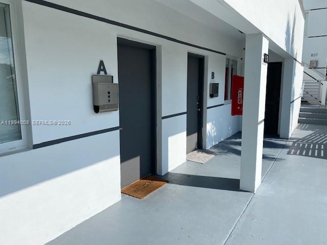 Exterior view of two apartment unit entrances labeled A and B with gray doors — 835 SW 8th Ave, Miami FL 33130, MIAMI, FL