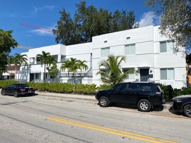 A white multi-story apartment building stands next to a street with parked cars — 835 SW 8th Ave, Miami FL 33130, MIAMI, FL