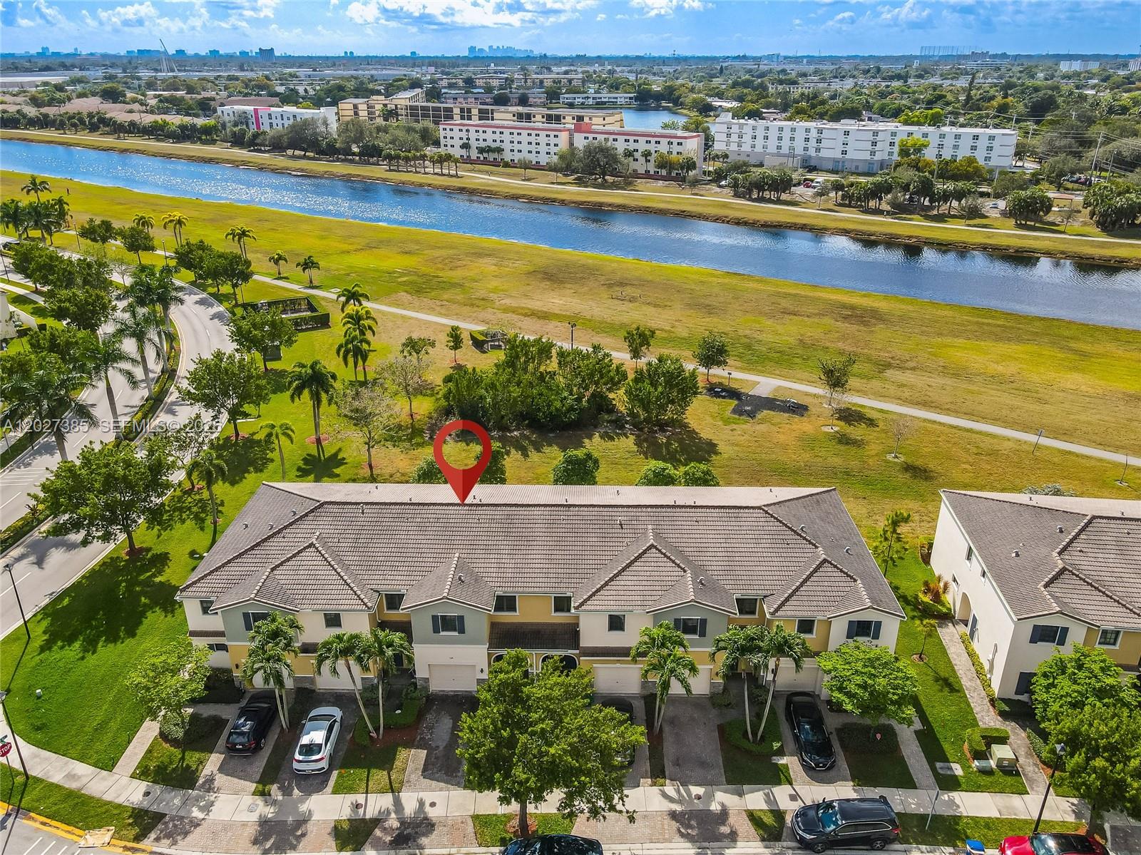 An aerial view shows a multi-unit townhouse building with a red location pin above — 311 NE 194th Ln # 311, Miami FL 33179, MIAMI, FL