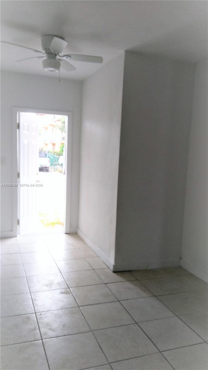 An interior view of a room with white walls, tiled floors, and an open doorway — 1821 SW 7th St # 7, Miami FL 33135, MIAMI, FL