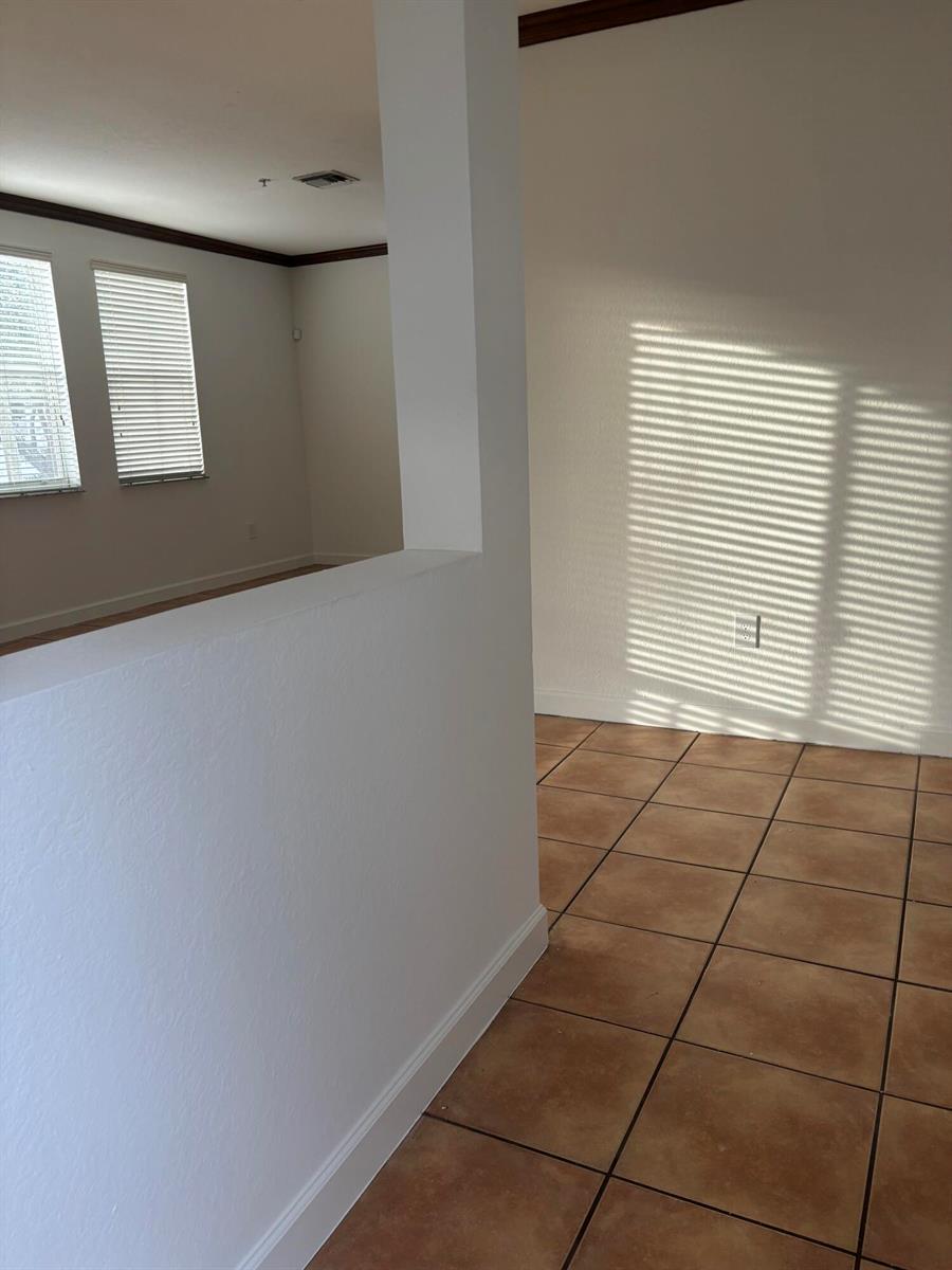 A white wall divides a tiled room from an adjacent space with windows and blinds — 4311 SW 160th Avenue # 210, Miramar FL 33027, MIRAMAR, FL