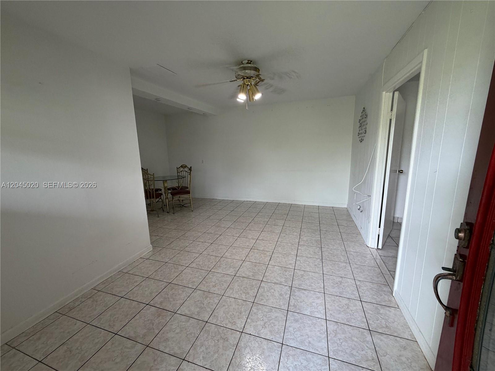 An empty room features white walls, a ceiling fan, and light-colored square floor tiles — 4935 SW 101st Ave # 1, Miami FL 33165, MIAMI, FL