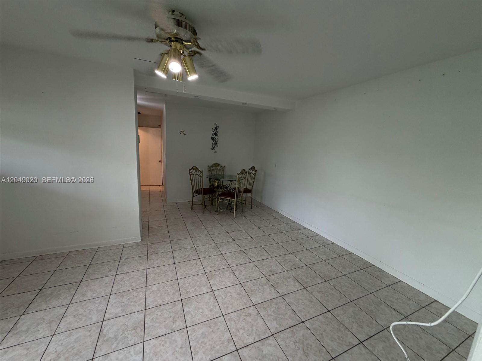 A dining area with tile flooring, a ceiling fan, and a small metal table set — 4935 SW 101st Ave # 1, Miami FL 33165, MIAMI, FL