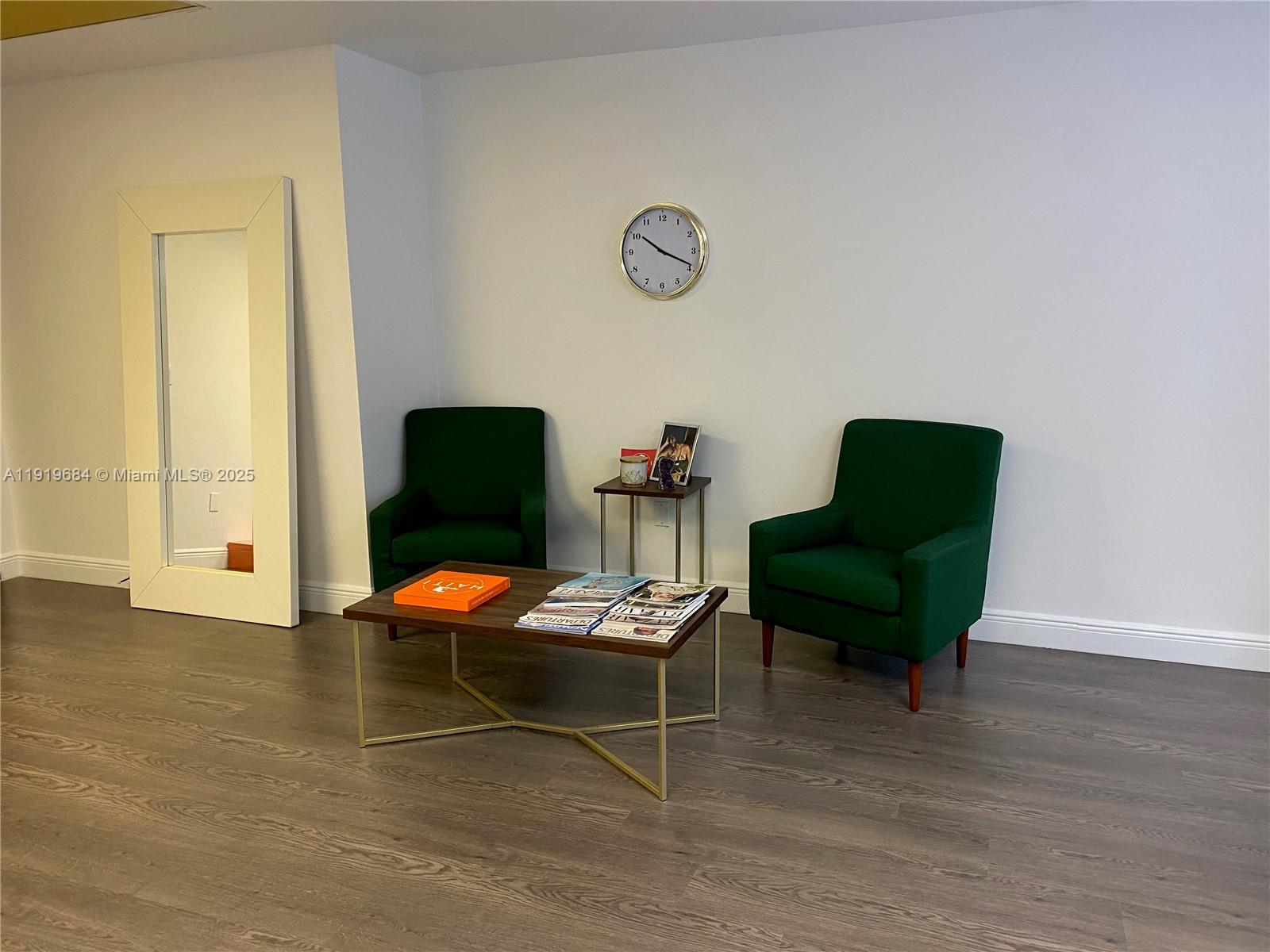 A waiting area features two green armchairs, a coffee table, a side table, and a mirror — 1110 Brickell Ave # 313, Miami FL 33131, MIAMI, FL