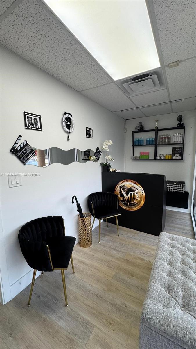A small salon reception area features two black velvet chairs, a desk, and wall decor — 213 Park Blvd, Miami FL 33126, MIAMI, FL