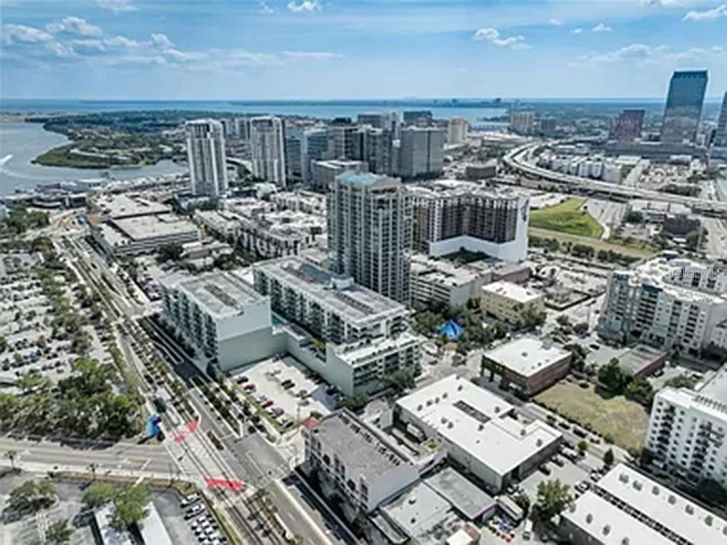 An aerial view of a dense urban cityscape featuring high-rise buildings and a nearby waterfront — 111 N 12TH STREET UNIT 1620, TAMPA, FL