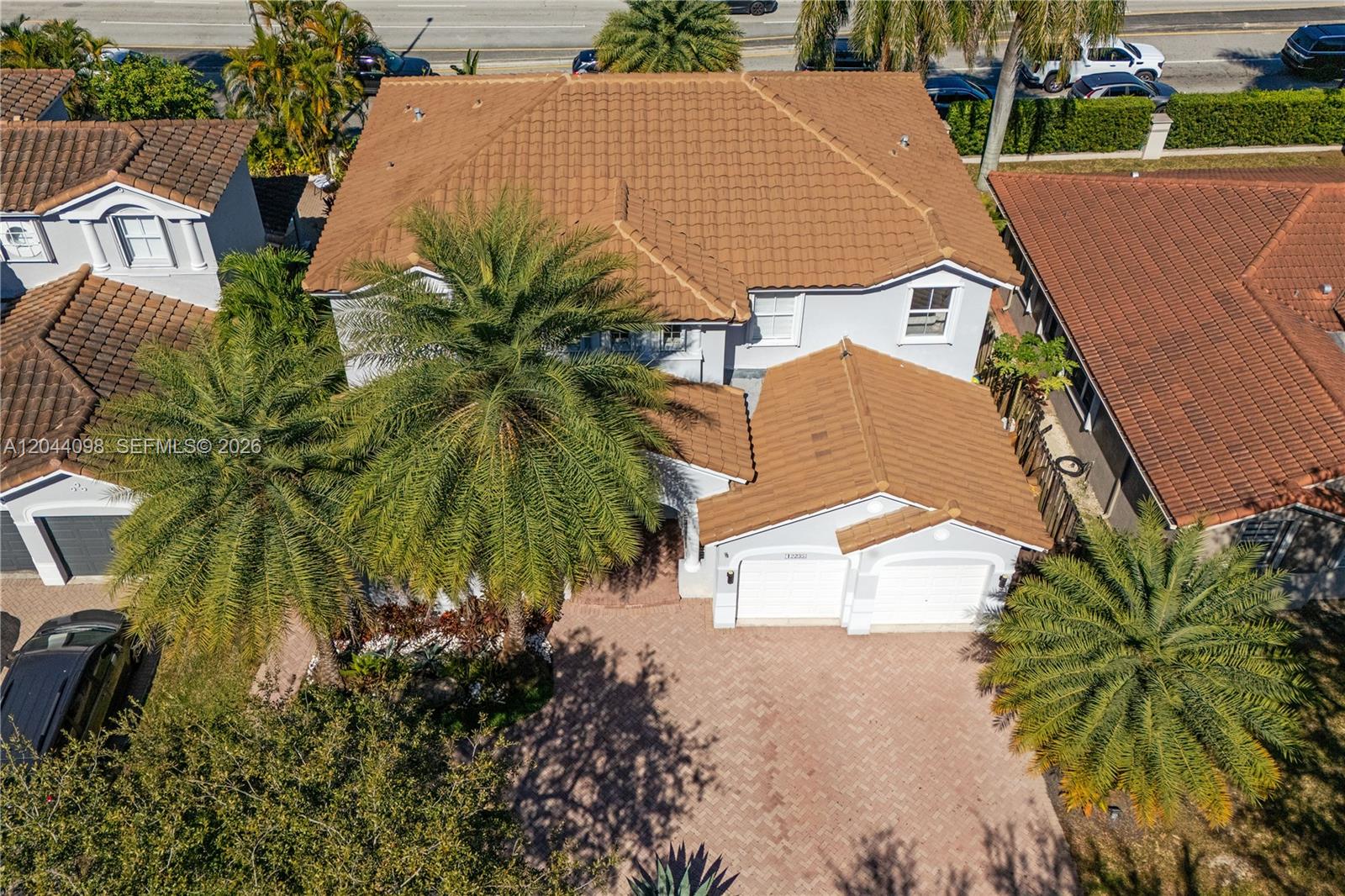 An aerial view shows a two-story house with a brown tile roof and palm trees — 12235 SW 121st Ter, Miami FL 33186, MIAMI, FL