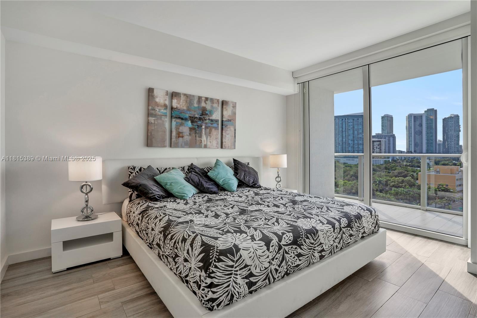 A modern bedroom features a patterned bed, white furniture, and a balcony with city views — 4250 Biscayne Blvd # 1116, Miami FL 33137, MIAMI, FL