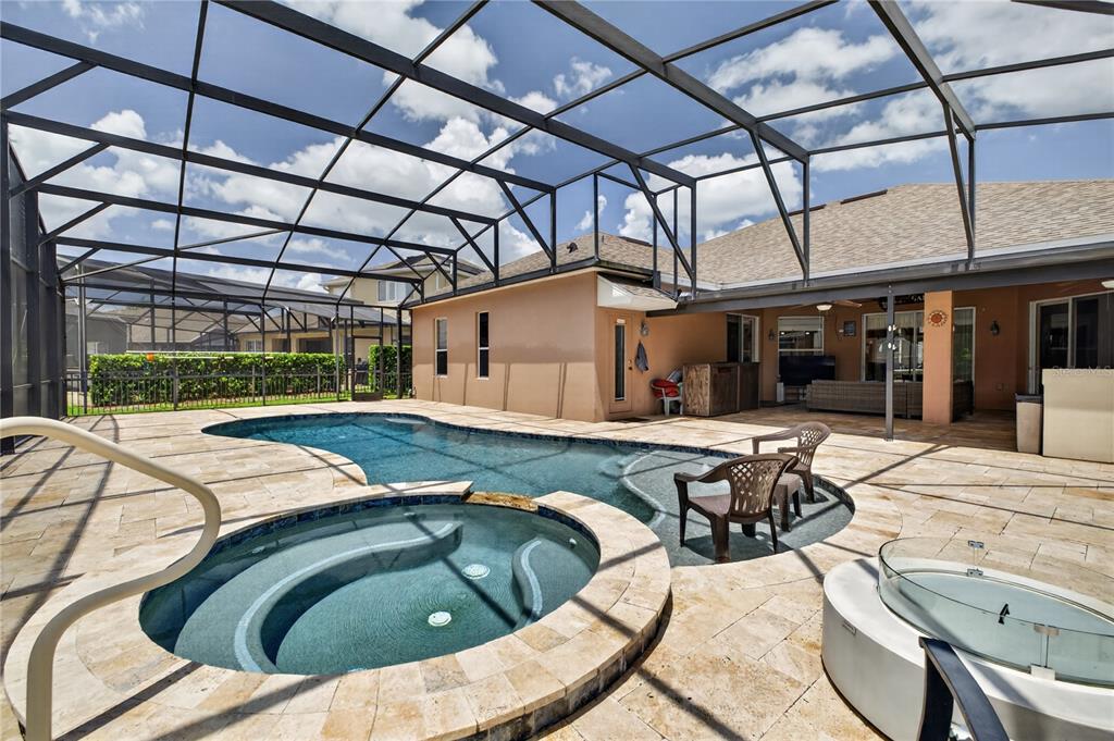 A single-story house with a tan stucco exterior, a front porch, and a two-car garage — 10174 MALLARD LANDINGS WAY, ORLANDO, FL