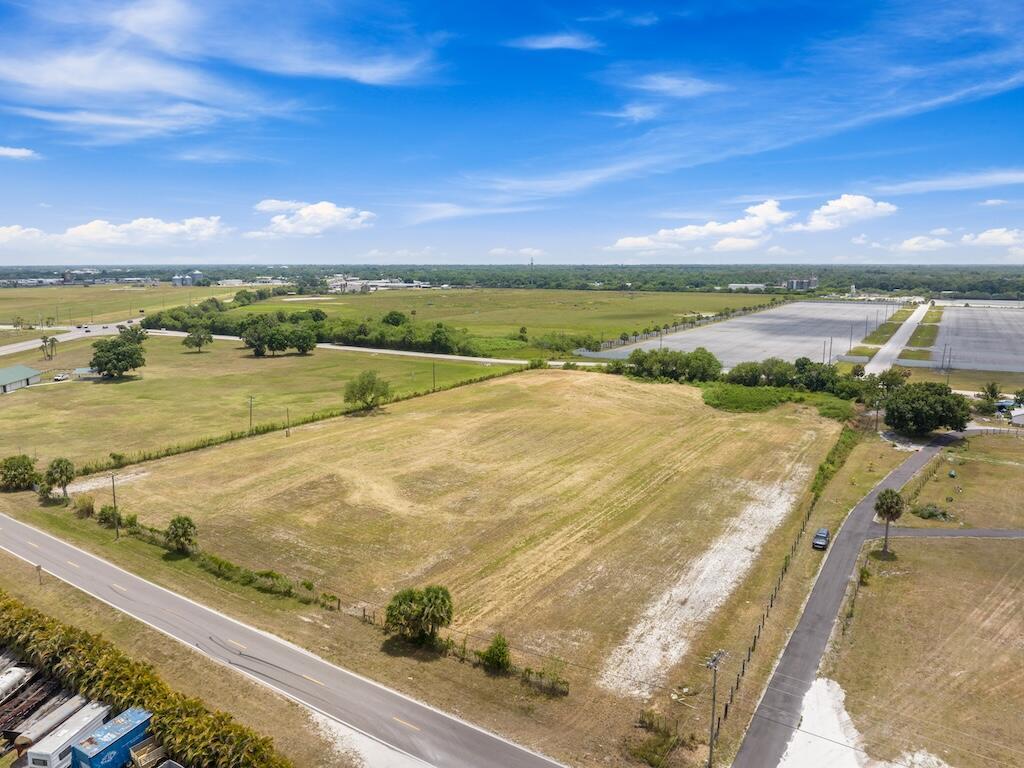 An aerial view shows a large, vacant, rectangular grassy lot bordered by two paved roads — 3274 NW 18th Street, Okeechobee FL 34972, OKEECHOBEE, FL