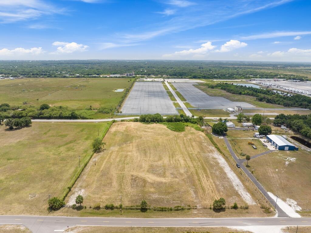 An aerial view shows a large, rectangular vacant lot bordering a paved road and industrial area — 3274 NW 18th Street, Okeechobee FL 34972, OKEECHOBEE, FL