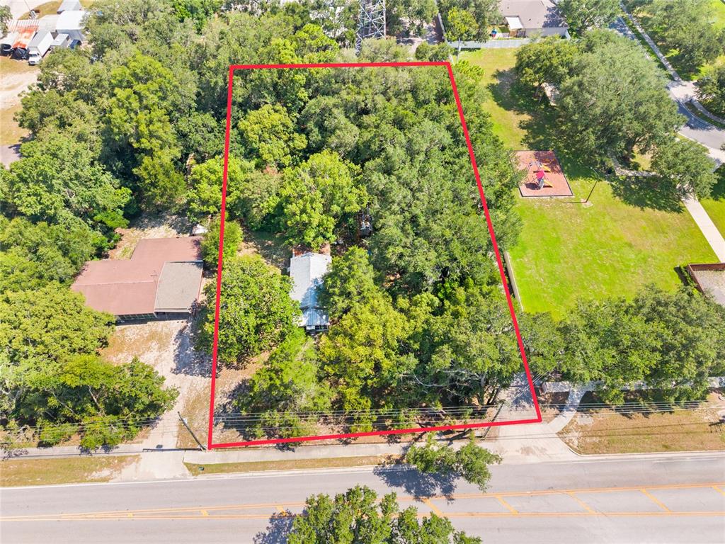 An aerial view shows a rectangular lot with a house surrounded by dense trees — 140 W PONKAN ROAD, APOPKA, FL