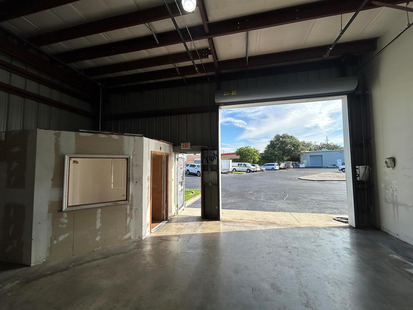 An interior view of a warehouse space with a large open bay door and office — 806 Old Dixie Highway # 1, Lake Park FL 33403, LAKE PARK, FL
