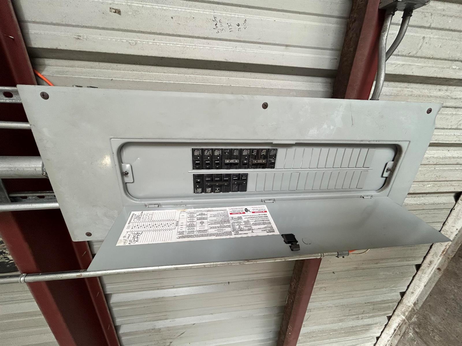 An open electrical breaker panel is mounted on a corrugated metal wall — 806 Old Dixie Highway # 1, Lake Park FL 33403, LAKE PARK, FL