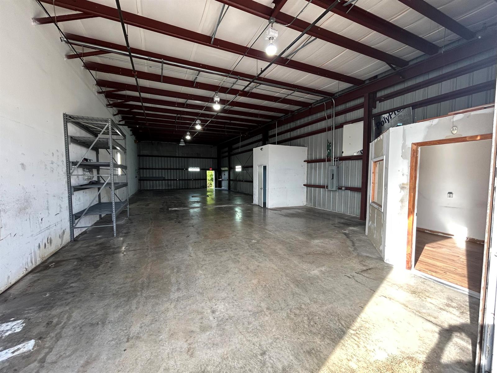 An industrial warehouse space features a concrete floor, metal ceiling beams, and an enclosed office — 806 Old Dixie Highway # 1, Lake Park FL 33403, LAKE PARK, FL