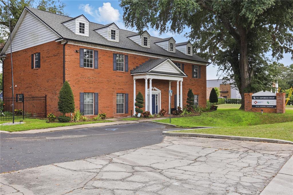 A two-story brick office building with a gabled roof and dormer windows — 5639 HANSEL AVENUE, ORLANDO, FL