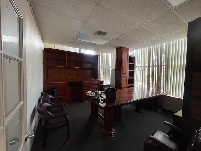 An office with a large wooden desk, matching wall shelving, and several leather chairs — 631 Us-1 # 101, North Palm Beach FL 33408, NORTH PALM BEACH, FL