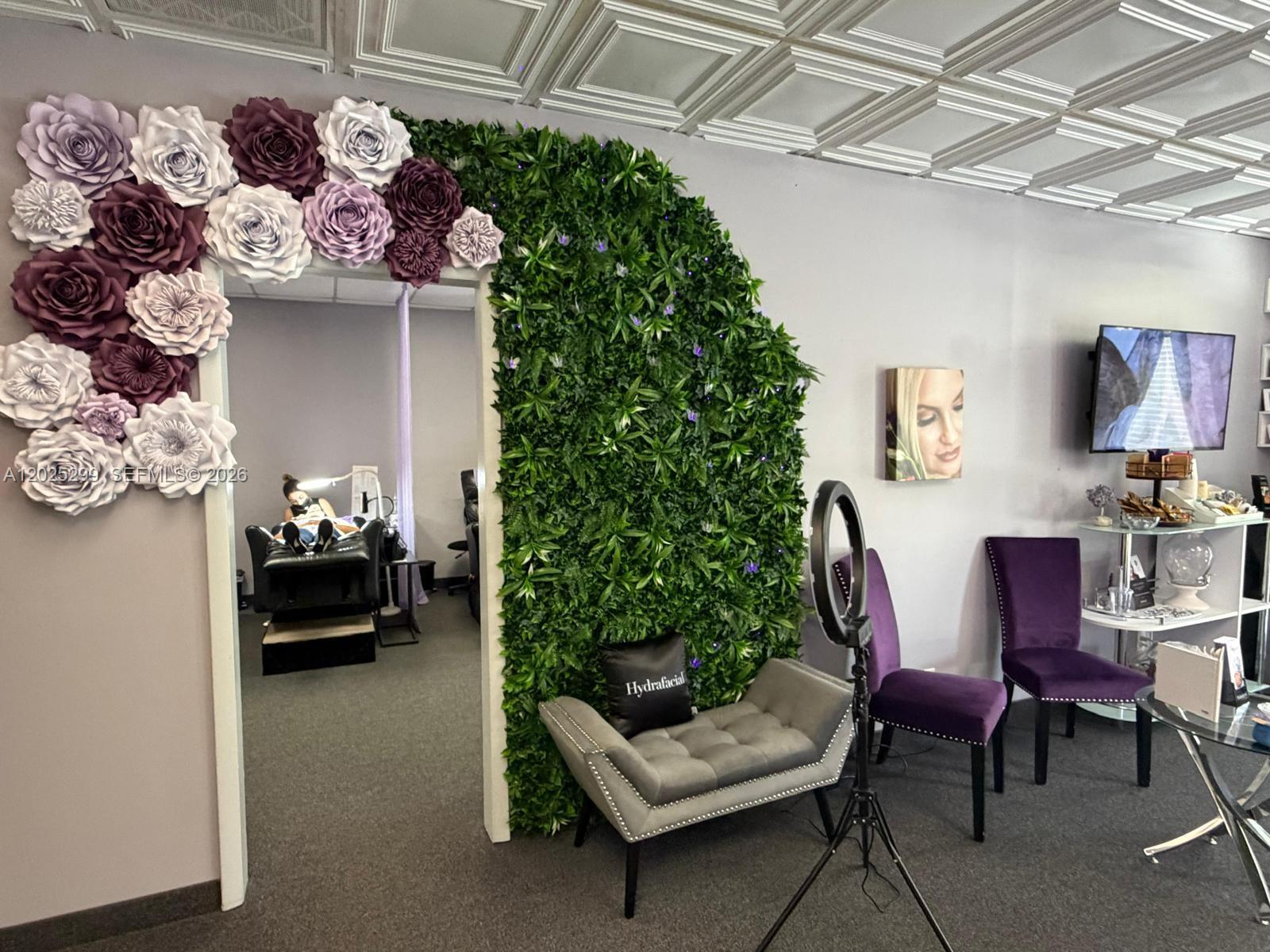 A spa treatment room features a floral-adorned doorway, a green wall, and purple seating — 2700-2750 N 29th Ave # 103, Hollywood FL 33020, HOLLYWOOD, FL