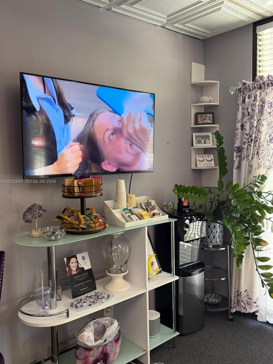 A waiting area features a wall-mounted television, a snack station, and a water cooler — 2700-2750 N 29th Ave # 103, Hollywood FL 33020, HOLLYWOOD, FL