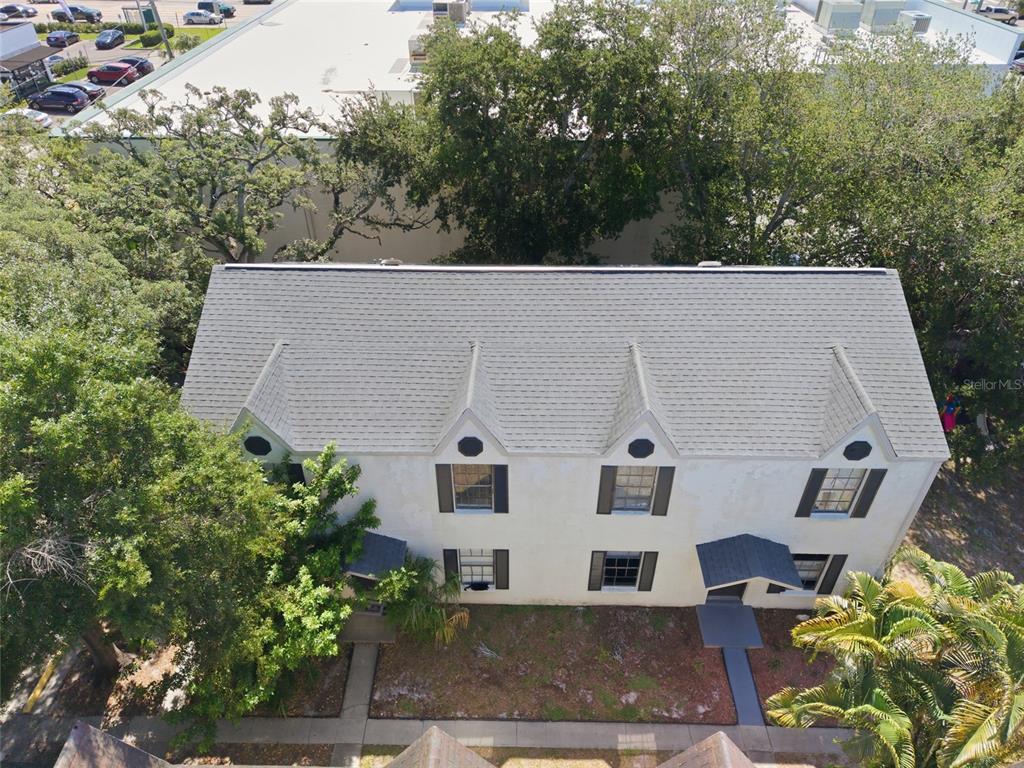 An aerial view of a two-story building with a gray shingled roof and dormers — 3810 W CLEVELAND STREET, TAMPA, FL