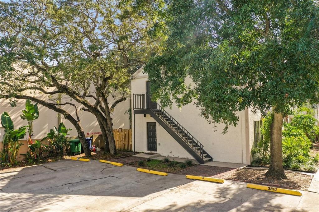 An exterior view of a two-story building with an outdoor staircase and parking spaces — 3810 W CLEVELAND STREET, TAMPA, FL