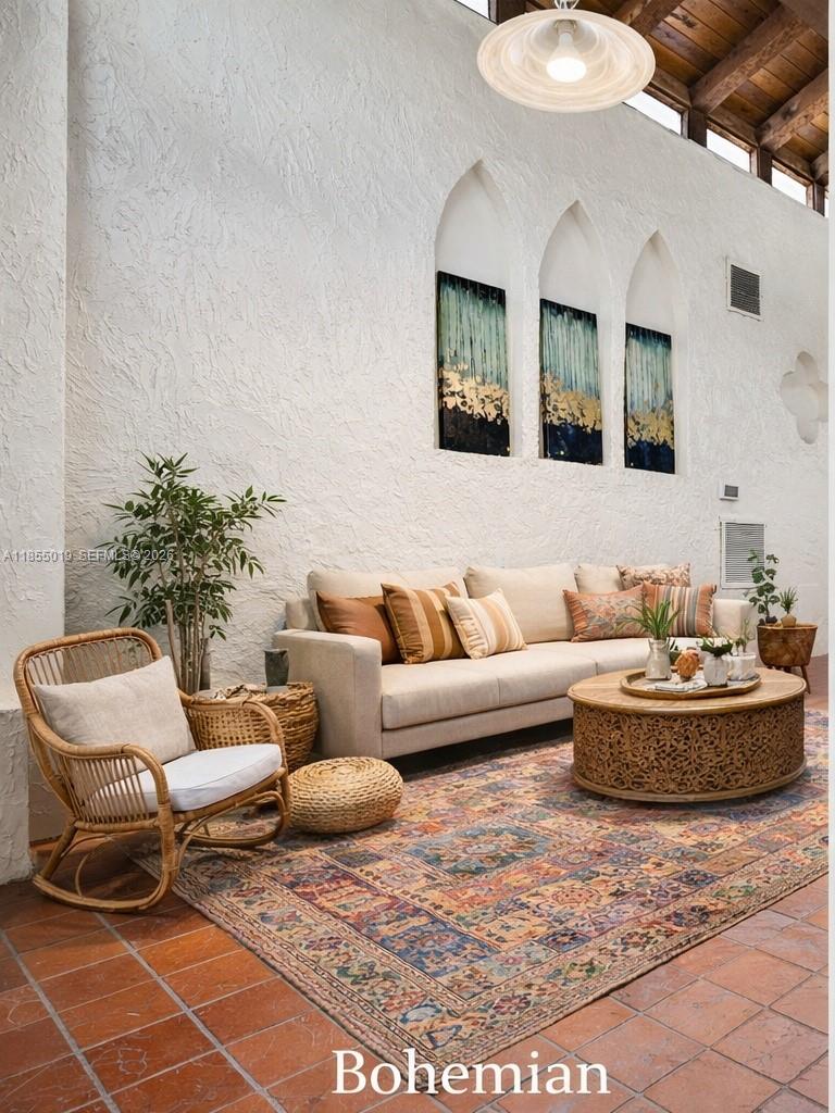 A living room features a beige sofa, a round carved coffee table, and a patterned rug — 3621 Lime Hill Rd # 202, Lauderhill FL 33319, LAUDERHILL, FL