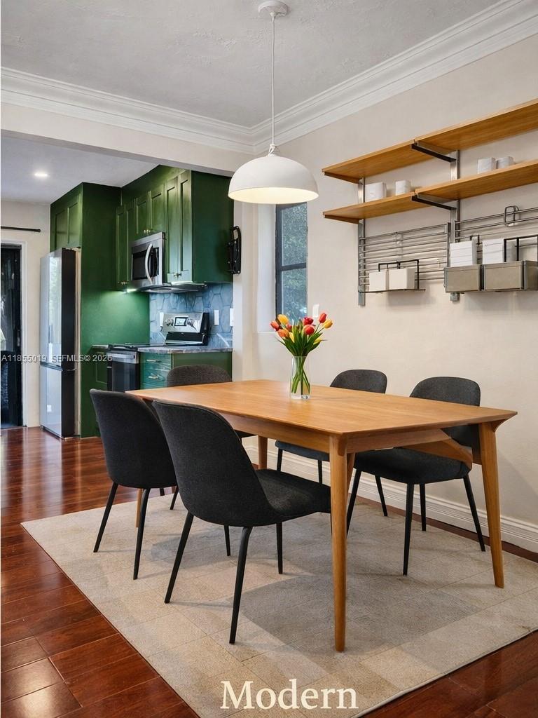 A dining area with a wooden table, dark chairs, and open shelving next to a kitchen — 3621 Lime Hill Rd # 202, Lauderhill FL 33319, LAUDERHILL, FL
