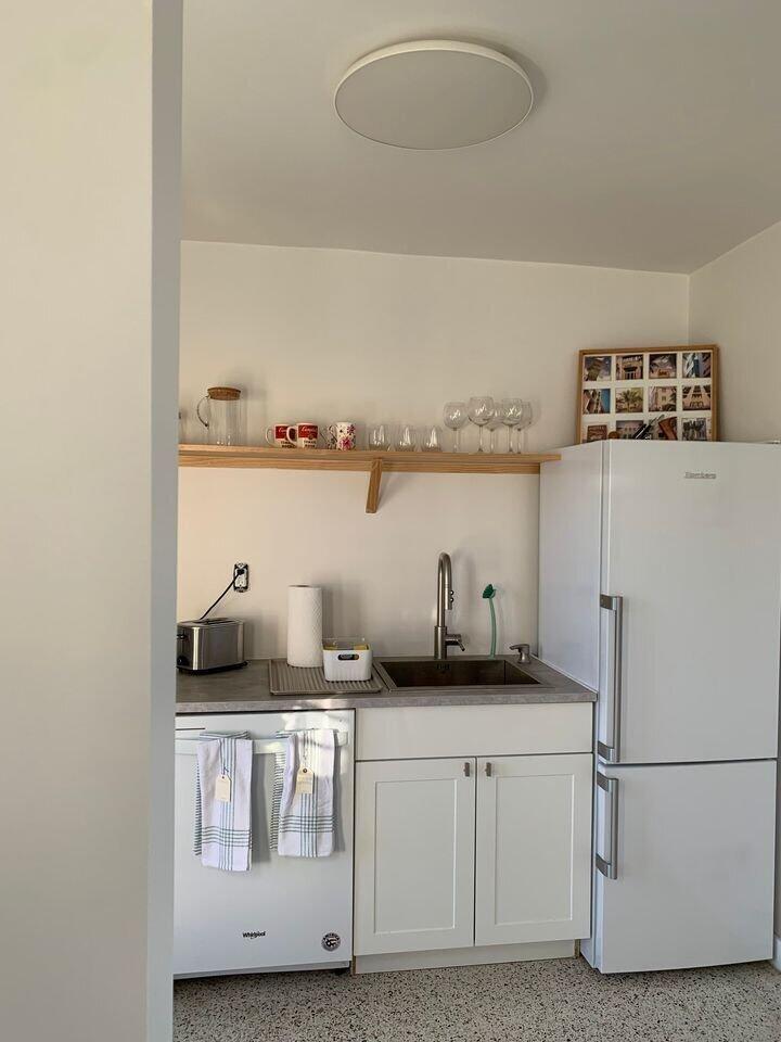 A small kitchen features white cabinets, a stainless steel sink, a refrigerator, and open shelving — 649 SW 9th Street # 301, Miami FL 33130, MIAMI, FL