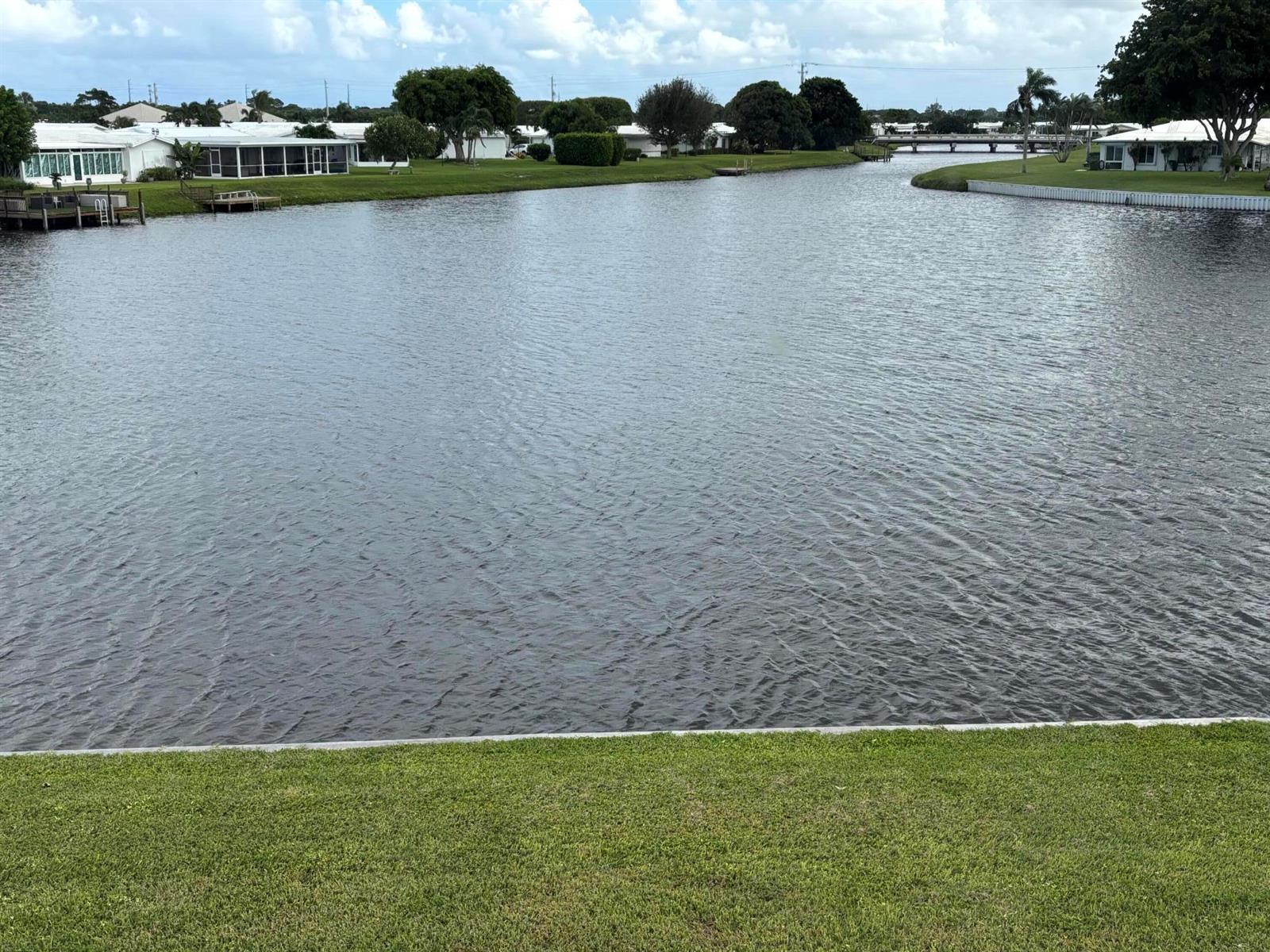 A view of a calm canal bordered by green lawns and residential homes — 1112 Lake Terrace # 207, Boynton Beach FL 33426, BOYNTON BEACH, FL