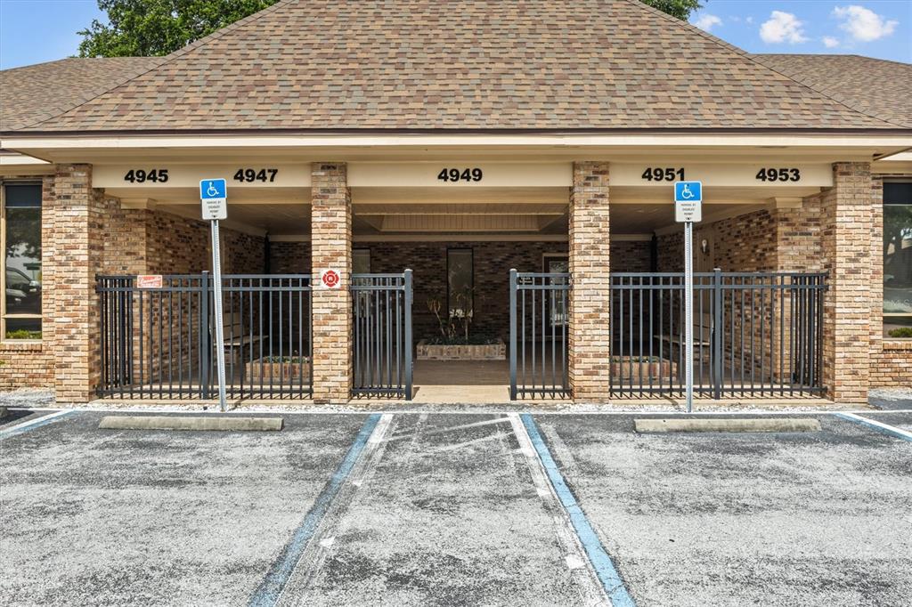 The exterior of a brick commercial building features multiple entrances and two handicap parking spaces — 4945 SOUTHFORK DRIVE, LAKELAND, FL
