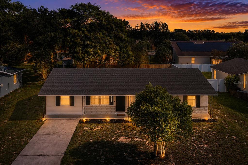 An aerial view of a single-story house with a gray roof and white brick exterior — 2112 EMBRY AVENUE, HAINES CITY, FL
