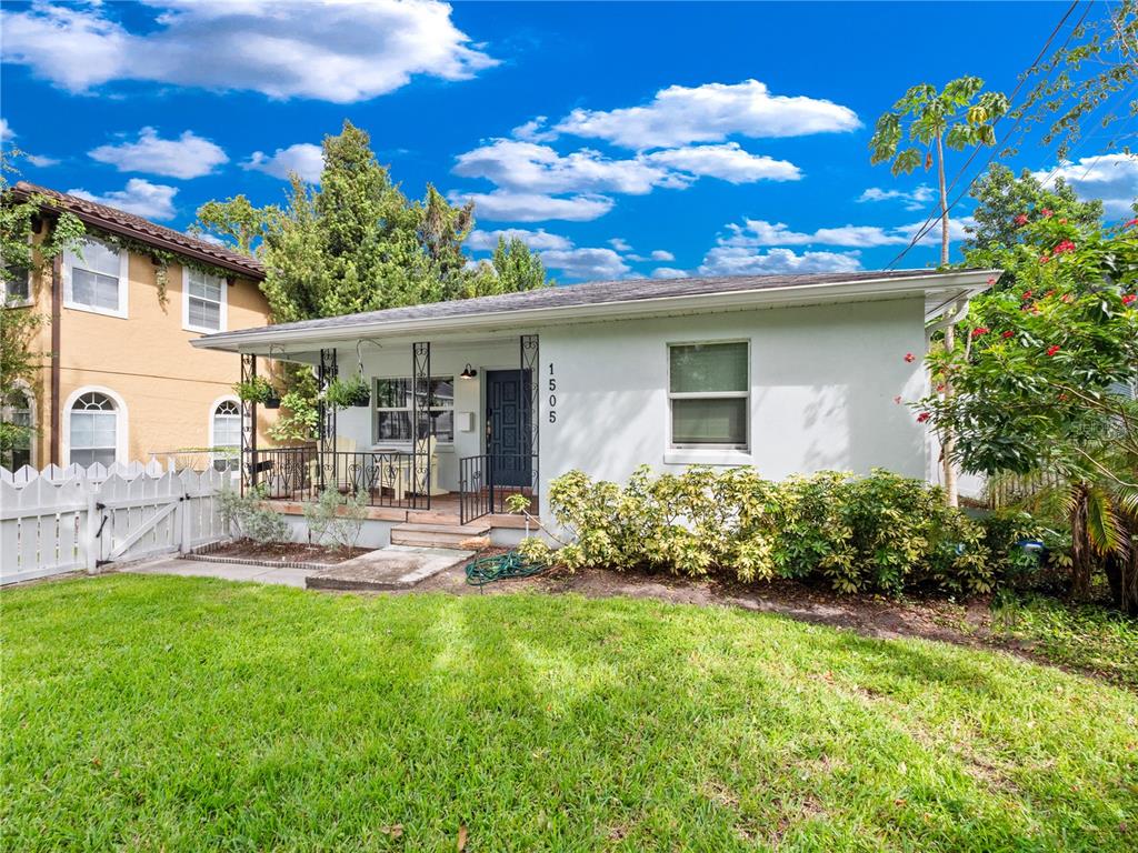A single-story white house with a front porch and a white picket fence — 1505 CATHERINE STREET, ORLANDO, FL