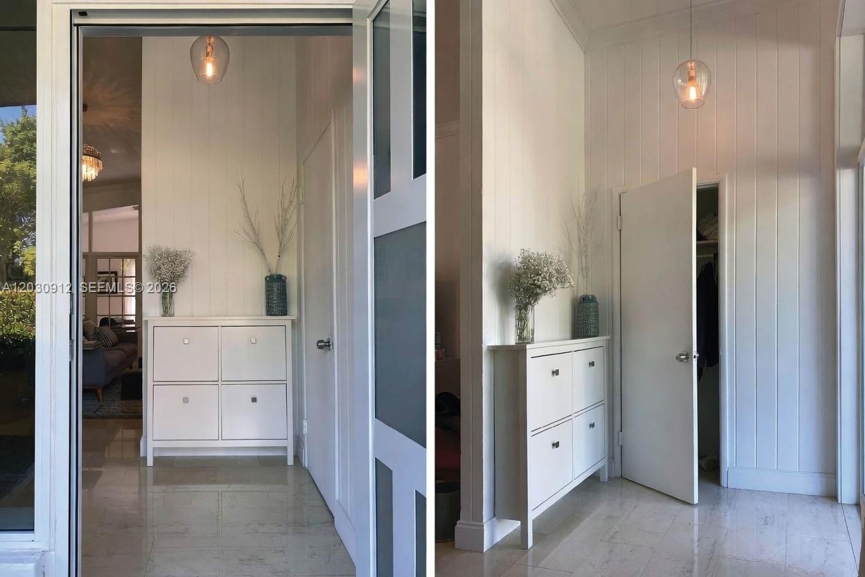A white entryway features a shoe cabinet, vertical wall paneling, and a closet door — 1030 NE 81st St, Miami FL 33138, MIAMI, FL