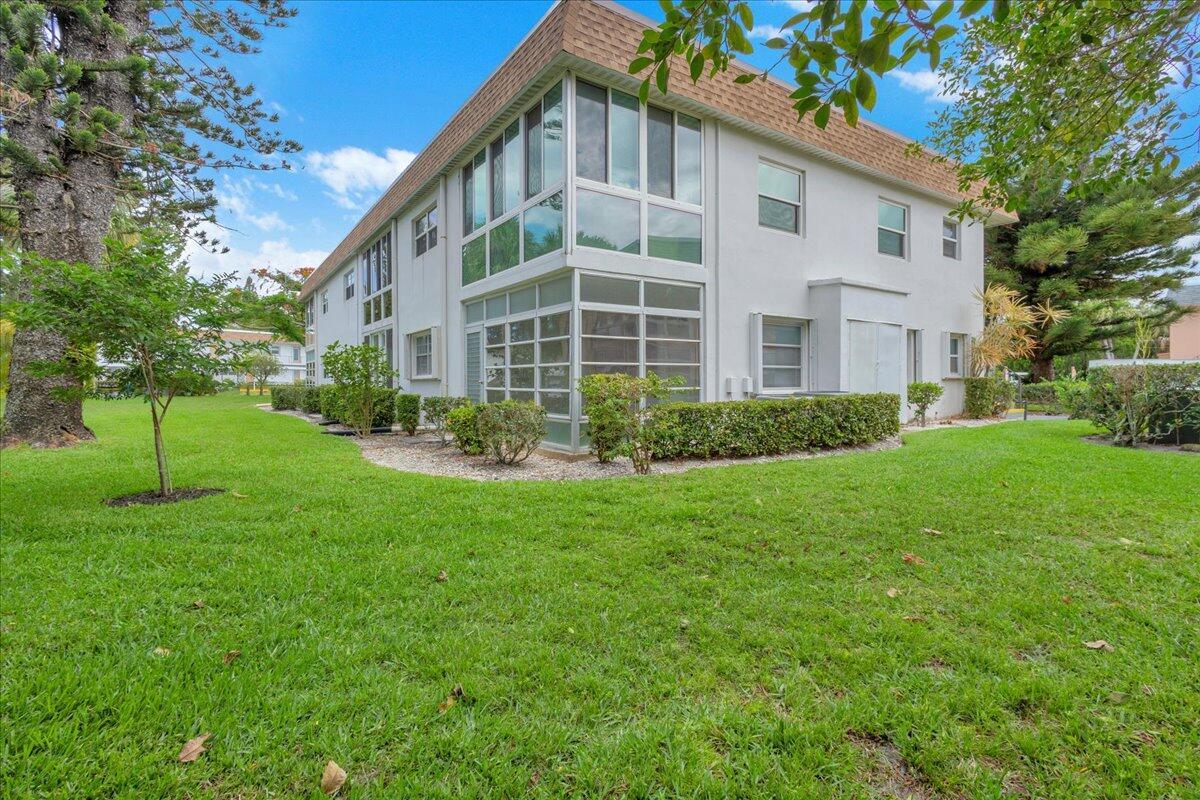 A two-story residential building with white stucco walls and a screened-in porch area — 2950 SE Ocean Boulevard # 1, Stuart FL 34996, STUART, FL