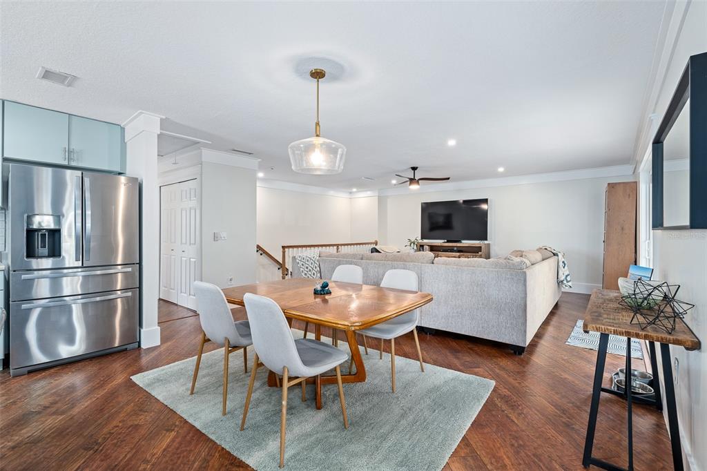 A dining area with a wooden table and chairs sits in front of a living room — 1339 S DAYTONA AVENUE, FLAGLER BEACH, FL