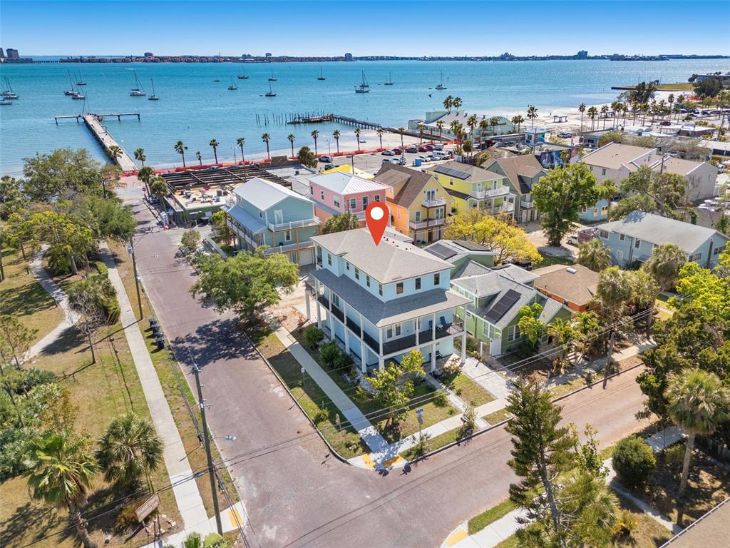 An aerial view shows a multi-story house with a red map pin near the coast — 5402 31ST AVENUE S, GULFPORT, FL