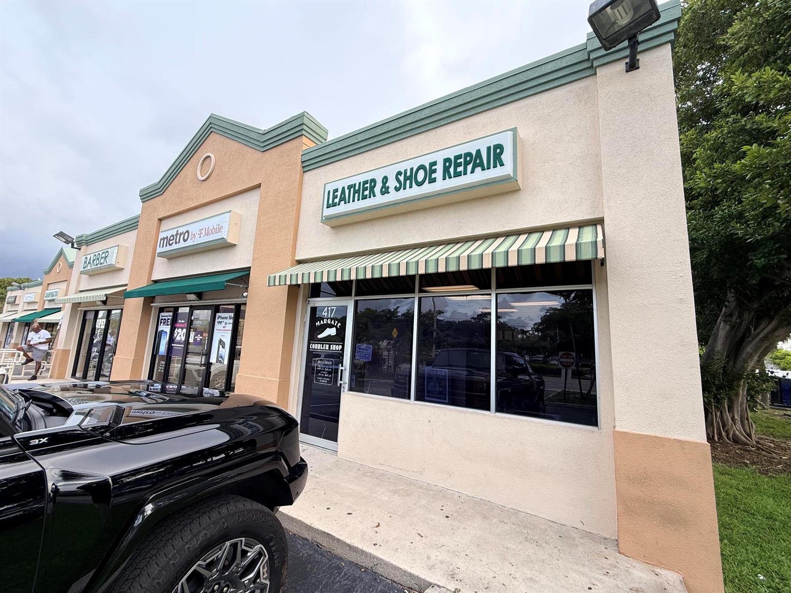 A storefront with a green and white striped awning and a leather and shoe repair sign — 417 N State Road 7 # 417, Margate FL 33063, MARGATE, FL