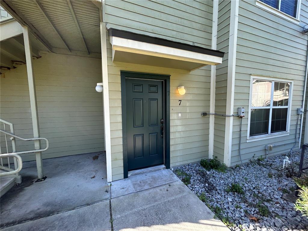 A dark green front door with the number seven sits under a small porch overhang — 3721 S LAKE ORLANDO PARKWAY UNIT 7, ORLANDO, FL