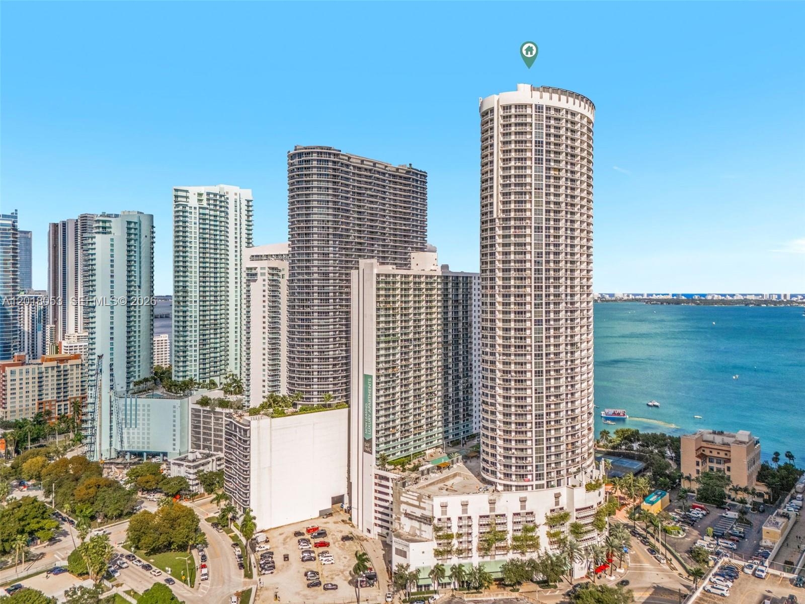 An aerial view shows several high-rise apartment buildings located along a waterfront — 1750 N Bayshore Dr # 1407, Miami FL 33132, MIAMI, FL