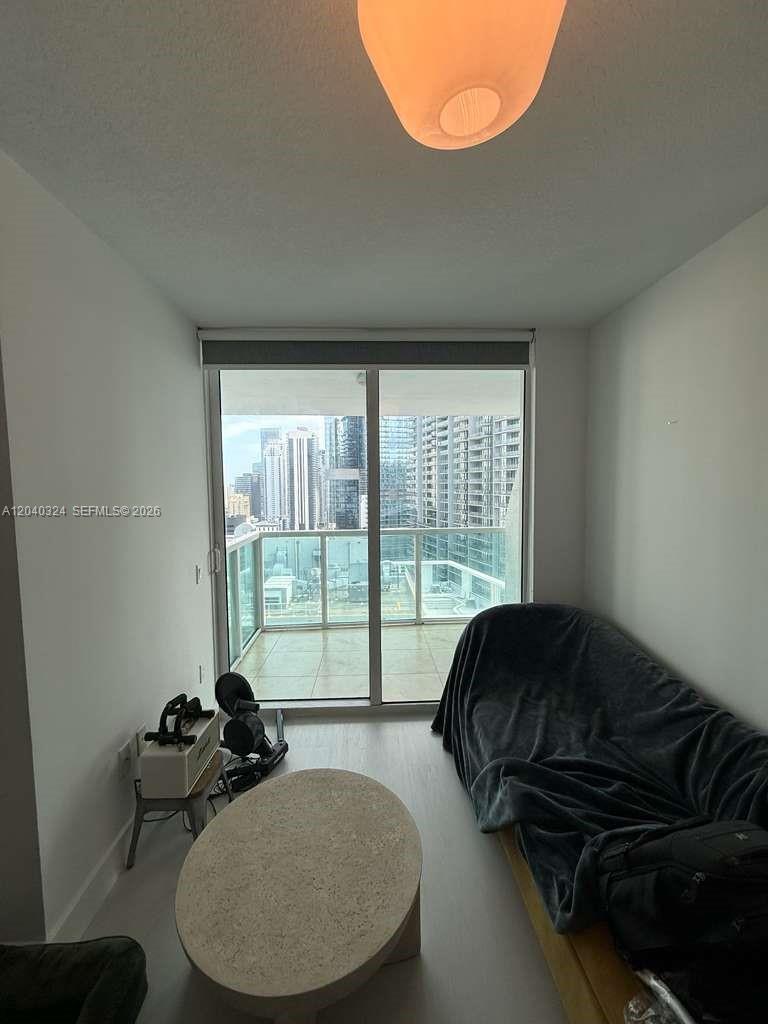 A small living room features a sofa, a coffee table, and a balcony with city views — 41 SE 5th St # 1708, Miami FL 33131, MIAMI, FL